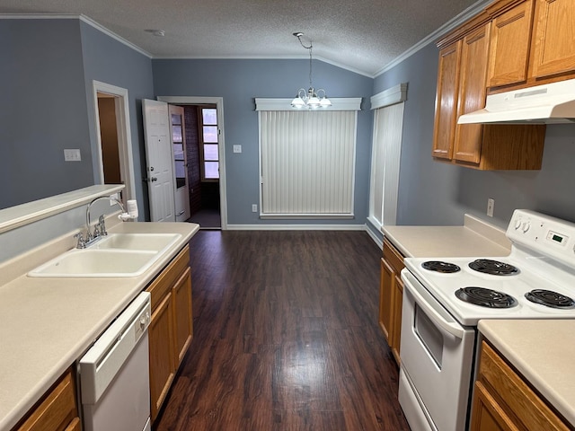 kitchen featuring pendant lighting, sink, white appliances, dark hardwood / wood-style floors, and a textured ceiling