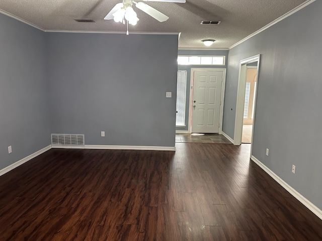 entryway featuring ceiling fan, ornamental molding, dark hardwood / wood-style flooring, and a textured ceiling