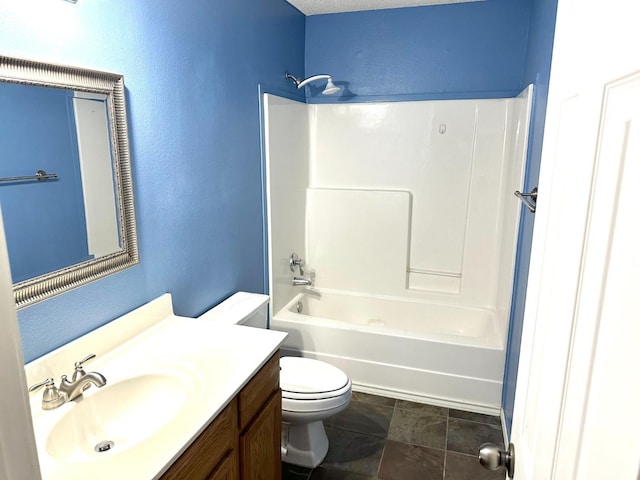 full bathroom with vanity, washtub / shower combination, and toilet