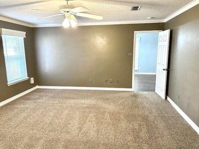 spare room featuring ornamental molding, carpet flooring, ceiling fan, and a textured ceiling