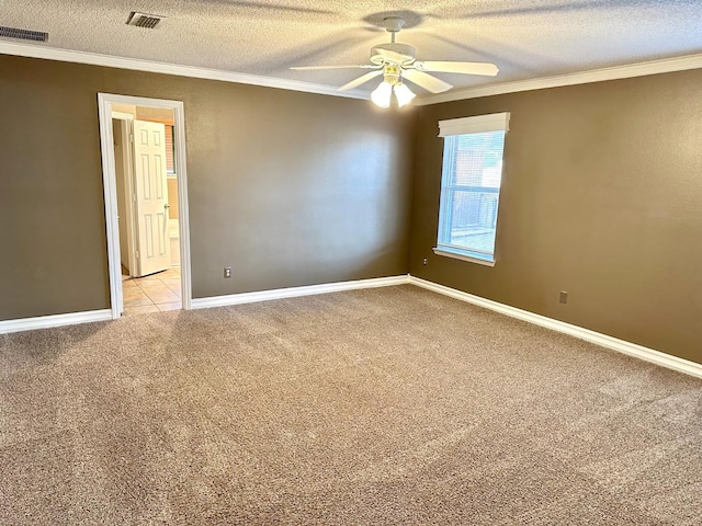 carpeted spare room featuring crown molding, ceiling fan, and a textured ceiling