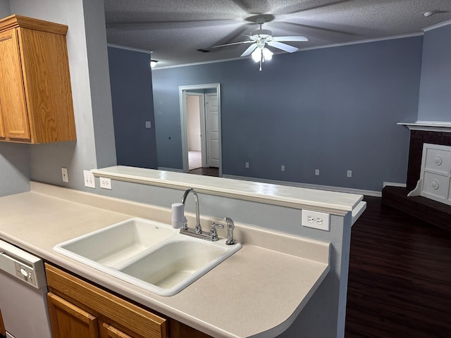 kitchen with sink, ceiling fan, white dishwasher, ornamental molding, and kitchen peninsula