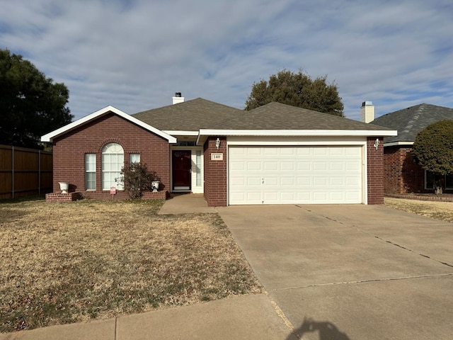 ranch-style house with a garage and a front yard