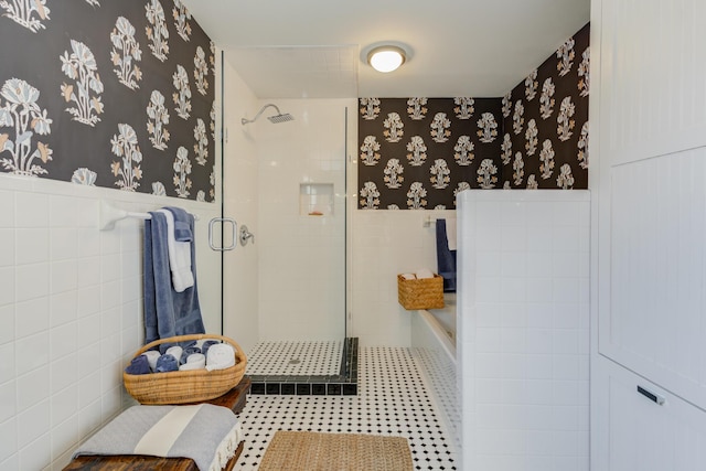 full bath featuring a shower stall, a garden tub, wainscoting, and wallpapered walls