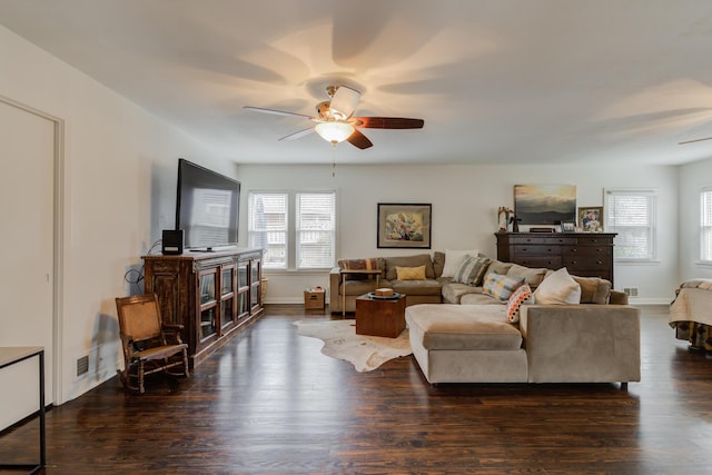 living area featuring visible vents, ceiling fan, wood finished floors, and baseboards