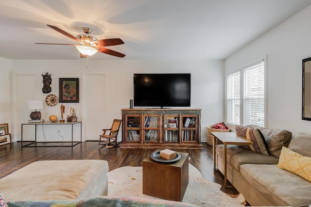 living area with a ceiling fan and wood finished floors
