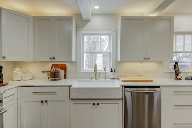 kitchen with stainless steel dishwasher, a sink, backsplash, and beam ceiling
