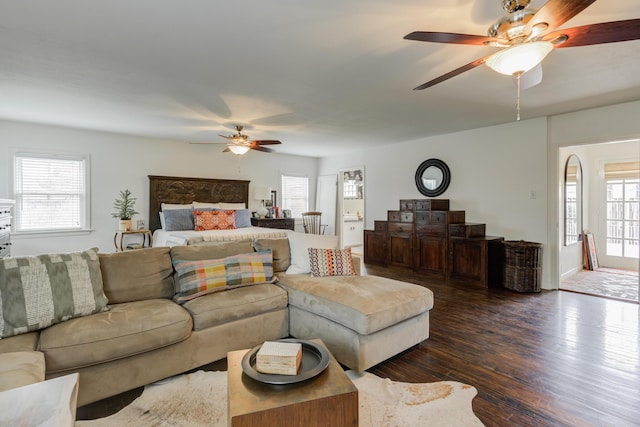 living room with dark wood-type flooring and ceiling fan