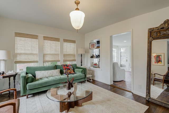 living room with baseboards and wood finished floors