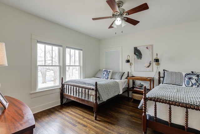 bedroom featuring baseboards, ceiling fan, and wood finished floors