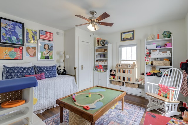rec room with wood finished floors, ceiling fan, and visible vents