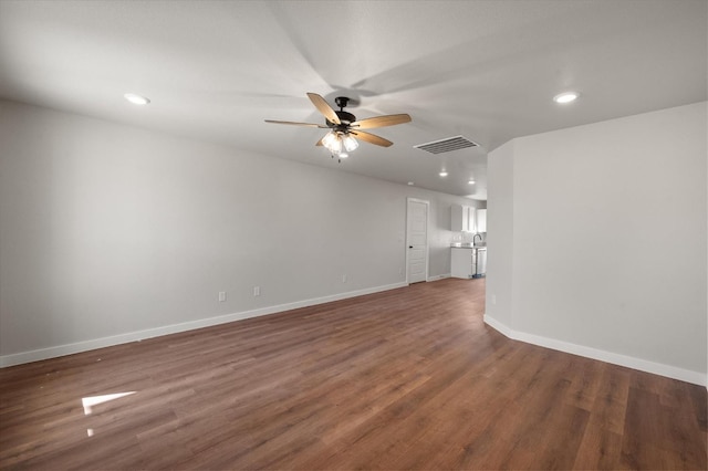 spare room with dark wood-type flooring and ceiling fan