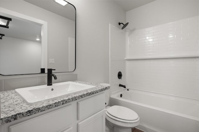 full bathroom featuring vanity, bathing tub / shower combination, and toilet