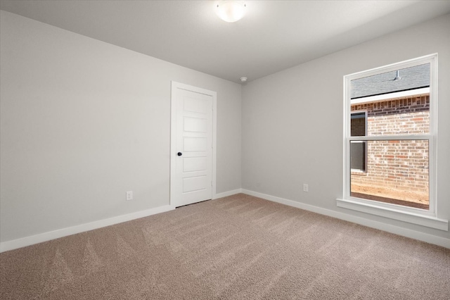 carpeted spare room with a healthy amount of sunlight