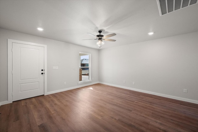 empty room featuring ceiling fan and dark hardwood / wood-style flooring