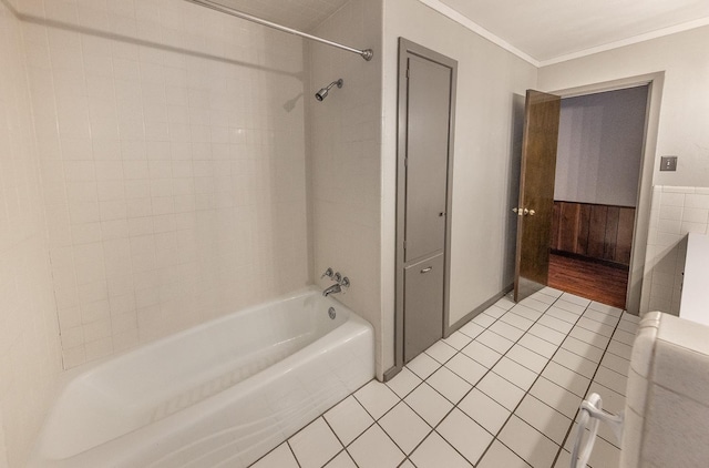 bathroom featuring tile patterned flooring, crown molding, and tiled shower / bath