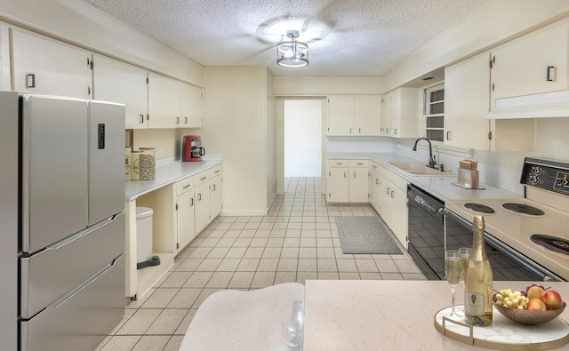 kitchen with white cabinetry, black dishwasher, sink, and stainless steel fridge