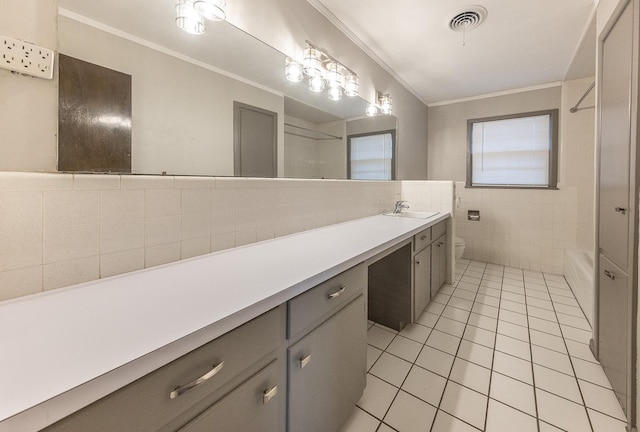 full bathroom with ornamental molding, tile walls, tile patterned floors, and toilet