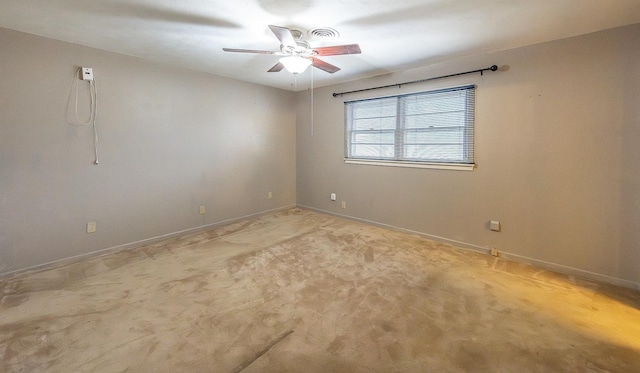 empty room with ceiling fan and light carpet