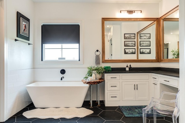 bathroom with vanity, a bathtub, and tile patterned floors