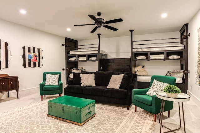 carpeted living room with ceiling fan