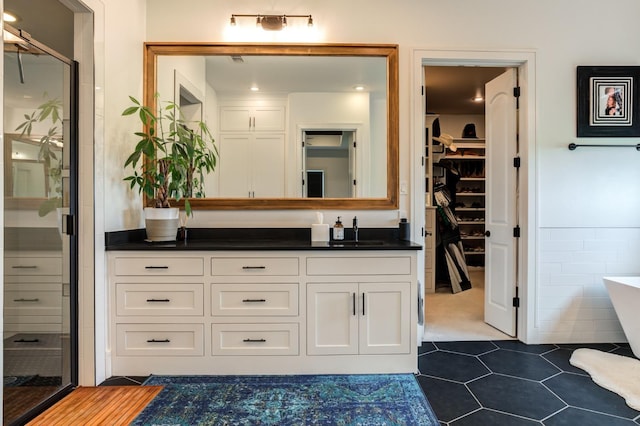 bathroom with vanity, tile patterned floors, and plus walk in shower