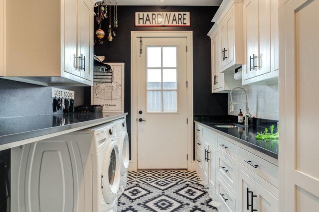 kitchen featuring tasteful backsplash, white cabinetry, sink, and washing machine and dryer