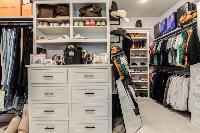 walk in closet featuring light carpet