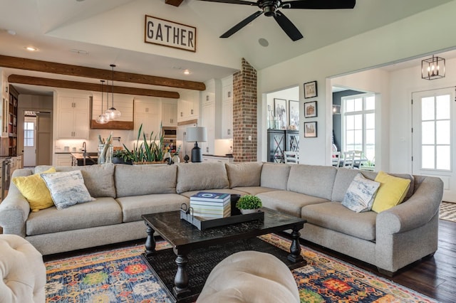 living room with dark wood-type flooring, lofted ceiling with beams, and ceiling fan