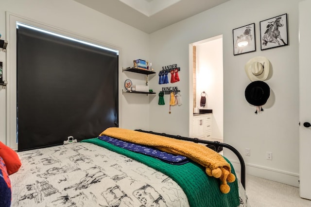 carpeted bedroom featuring ensuite bath