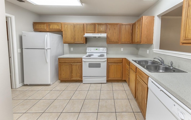 kitchen with white appliances, sink, and light tile patterned floors