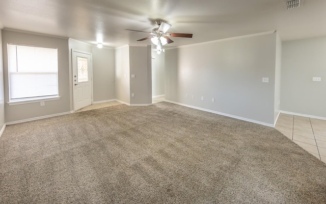 tiled spare room with ceiling fan and ornamental molding