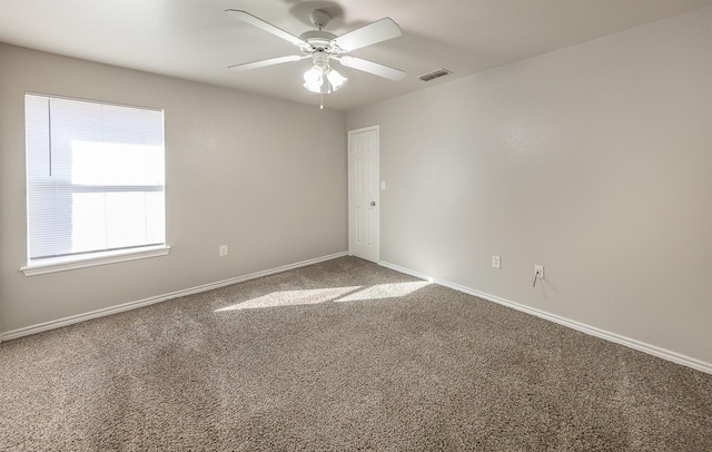 carpeted spare room featuring ceiling fan