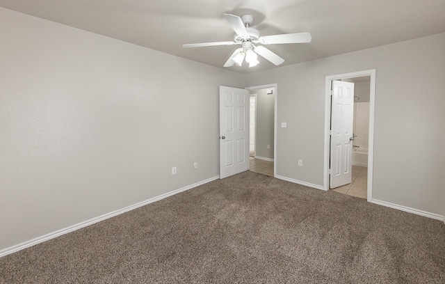 unfurnished bedroom featuring light carpet, ensuite bath, and ceiling fan