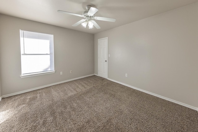 unfurnished room featuring ceiling fan and carpet