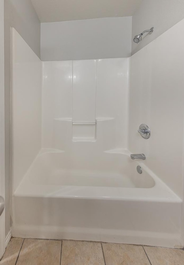 bathroom featuring tile patterned flooring and shower / bathtub combination