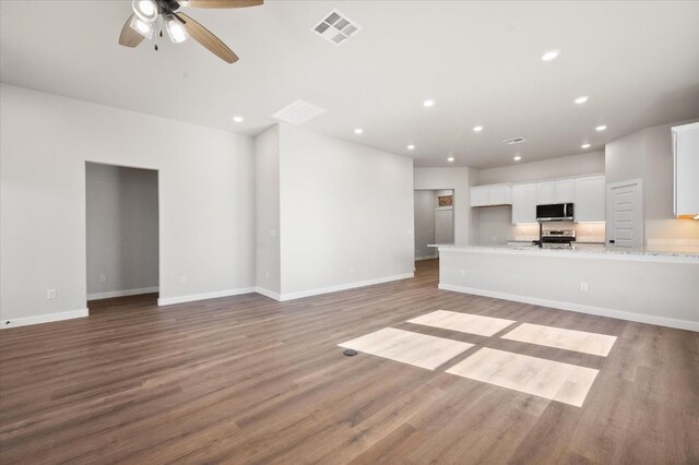 unfurnished living room with ceiling fan, sink, and light hardwood / wood-style floors