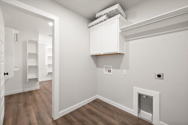 clothes washing area featuring washer hookup, cabinets, dark hardwood / wood-style flooring, and hookup for an electric dryer