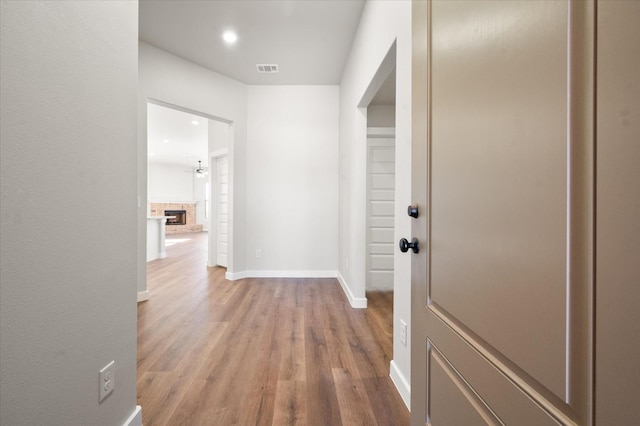 corridor with light hardwood / wood-style floors