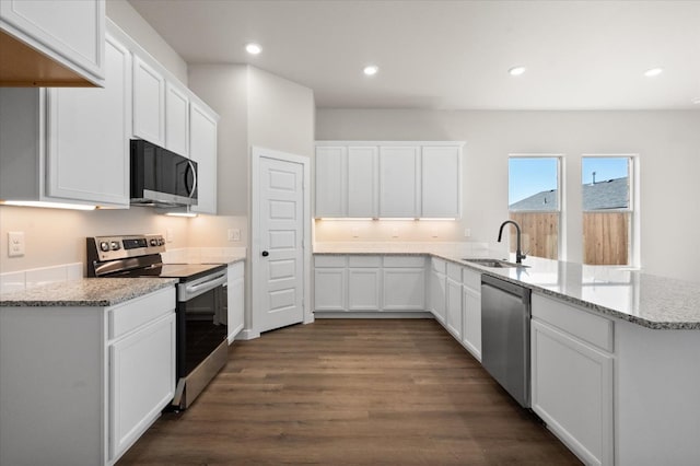 kitchen featuring white cabinetry, sink, kitchen peninsula, and appliances with stainless steel finishes