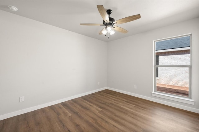 empty room featuring ceiling fan and dark hardwood / wood-style flooring