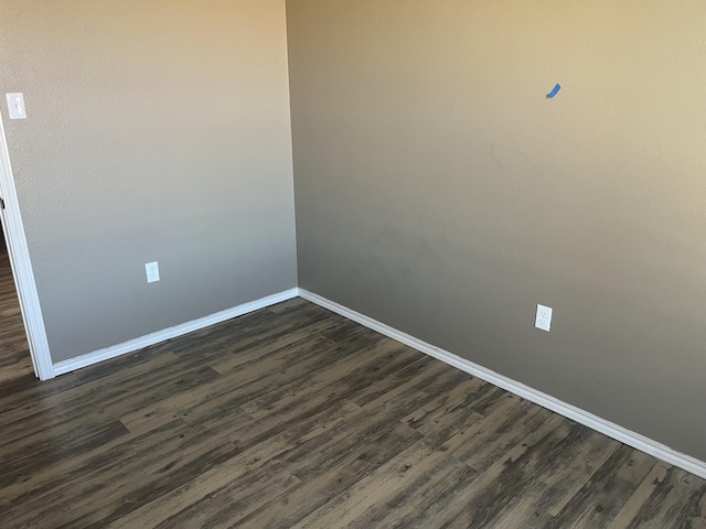 empty room with dark hardwood / wood-style floors