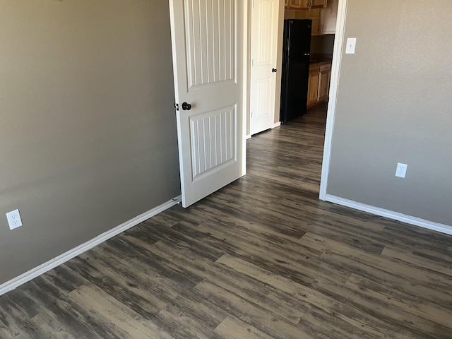 hallway with dark hardwood / wood-style floors