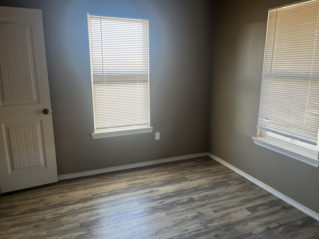 empty room with dark hardwood / wood-style floors