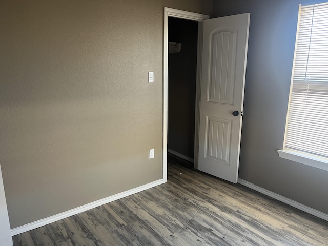 unfurnished room featuring dark hardwood / wood-style flooring