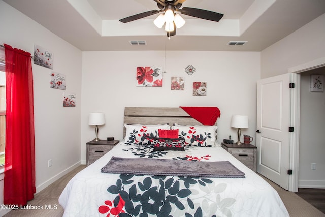 5719 117th St, Lubbock, TX 79424 - bedroom with a tray ceiling, baseboards, and a ceiling fan