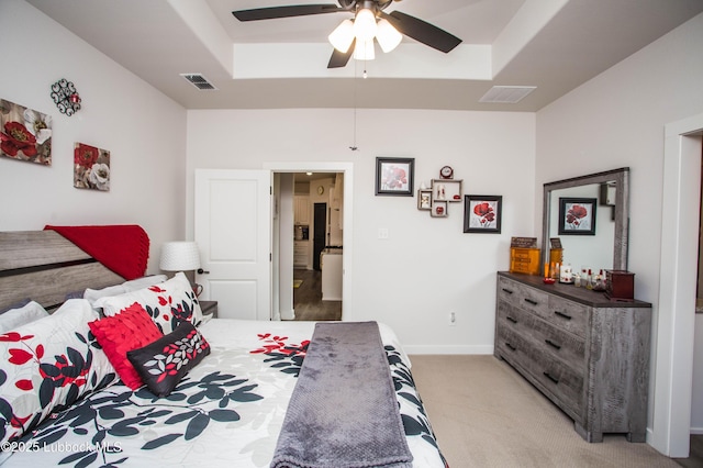 5719 117th St, Lubbock, TX 79424 - bedroom with light carpet, a raised ceiling, baseboards, and ceiling fan