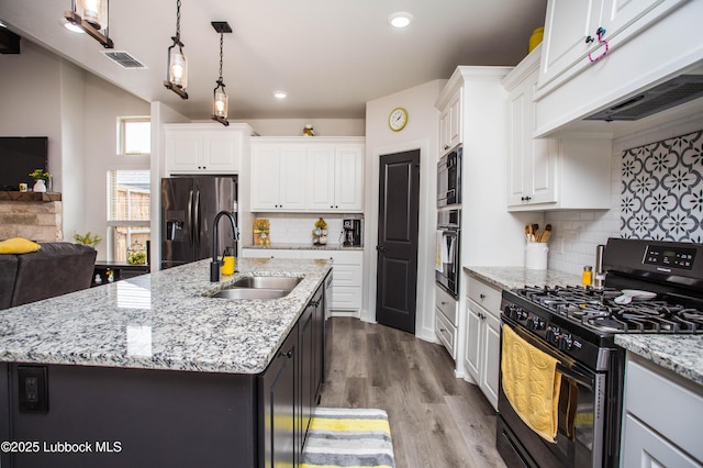 5719 117th St, Lubbock, TX 79424 - kitchen featuring black range with gas stovetop, a sink, fridge with ice dispenser, wall oven, and custom exhaust hood