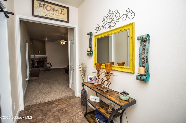7023 35th St, Lubbock, TX 79407 - hallway featuring baseboards and dark carpet