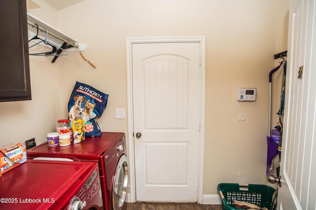 7023 35th St, Lubbock, TX 79407 - laundry area featuring baseboards, independent washer and dryer, and cabinet space